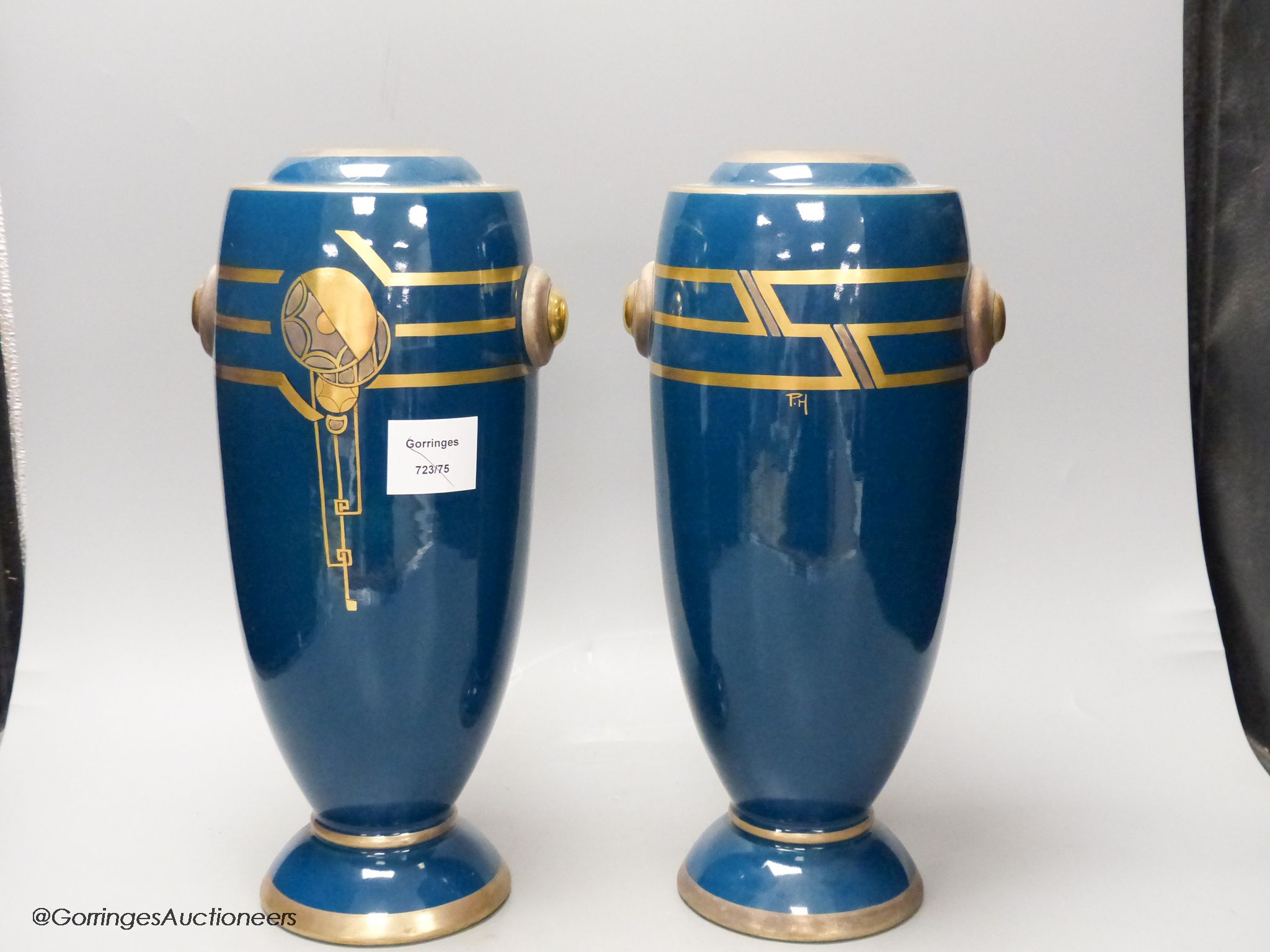 A pair of Art Deco blue glazed pottery vases, initialled PH, height 36cm